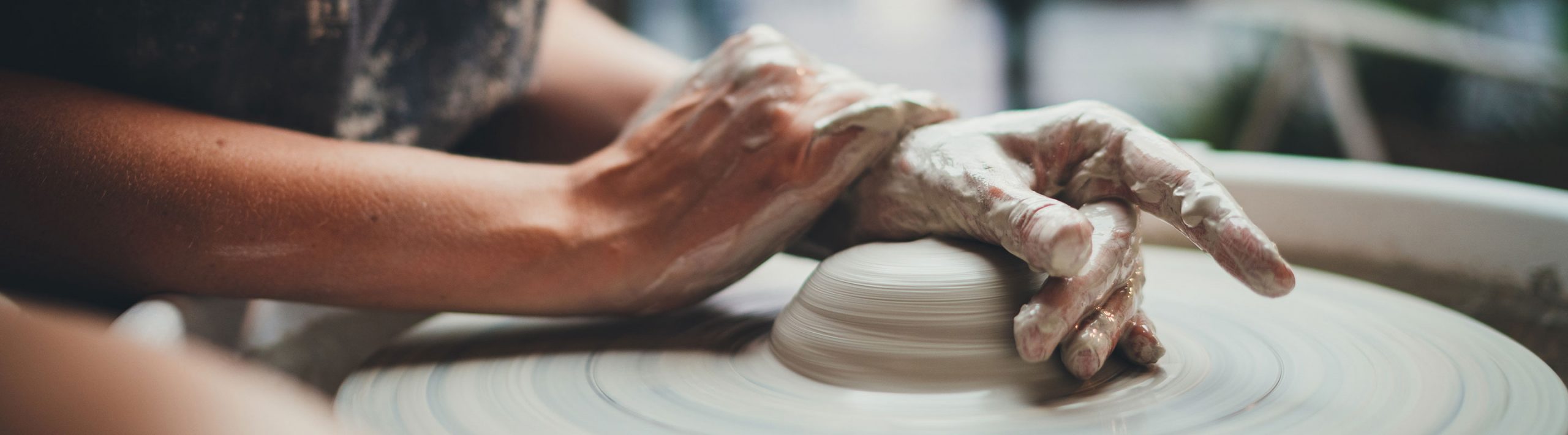 ceramicist working with clay on a wheel