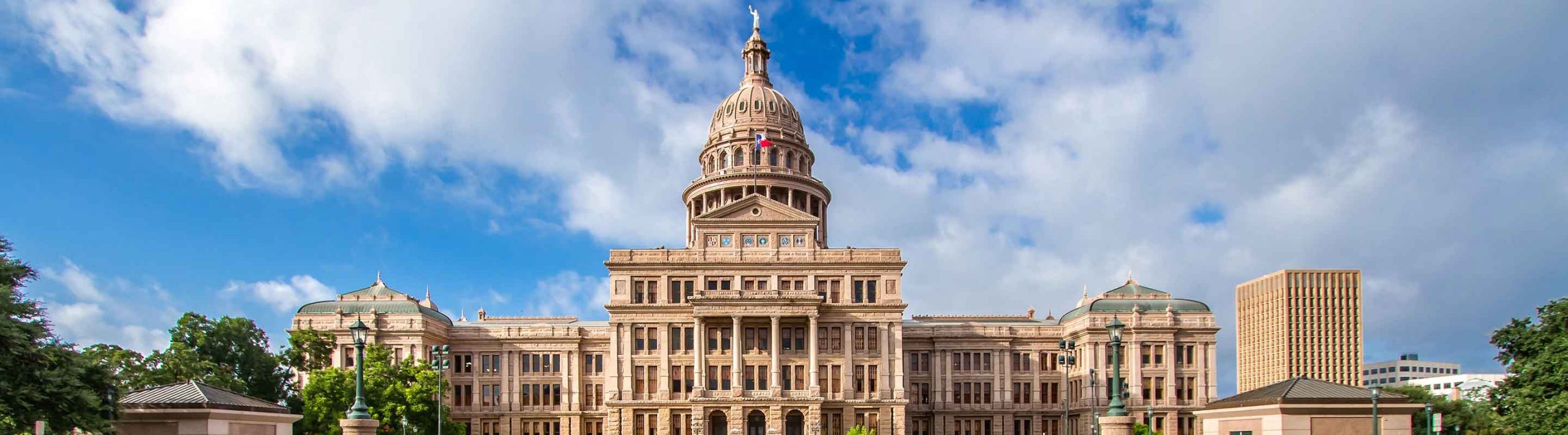 Texas State Capitol building with Texas flag