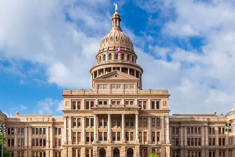 Texas State Capitol building with Texas flag