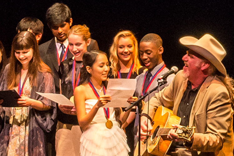 Texas Young Masters awards recipients on stage with medals