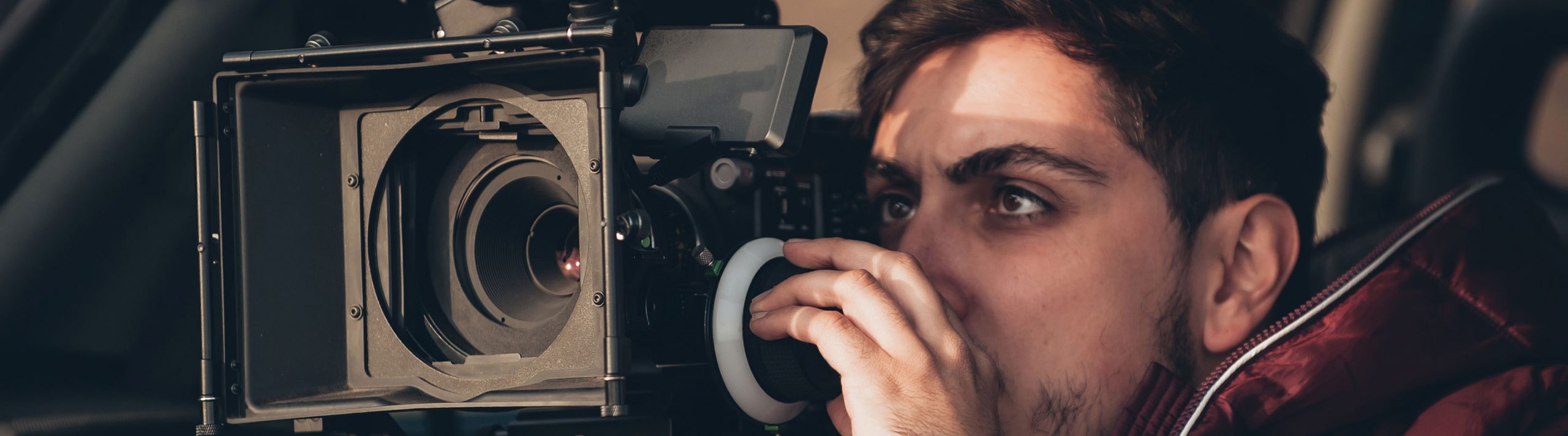 man filming with video camera