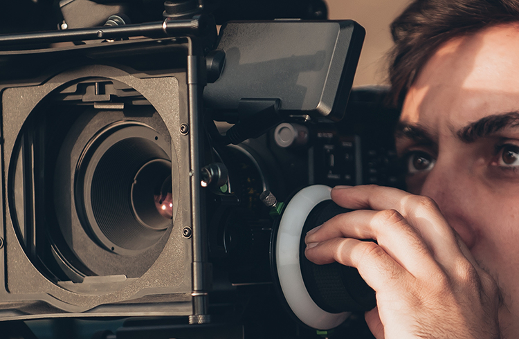 man filming with video camera